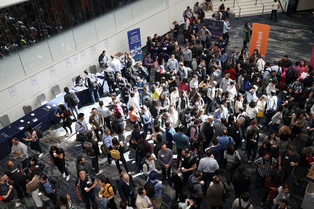 Large crowd gathered in a conference hall, seen from above